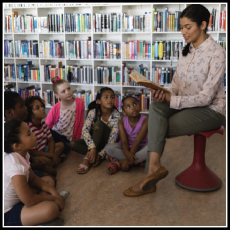Teacher reading aloud to students
