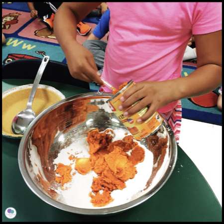 Children making pumpkin pie. 