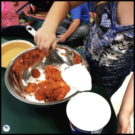 Children making pumpkin pie. 